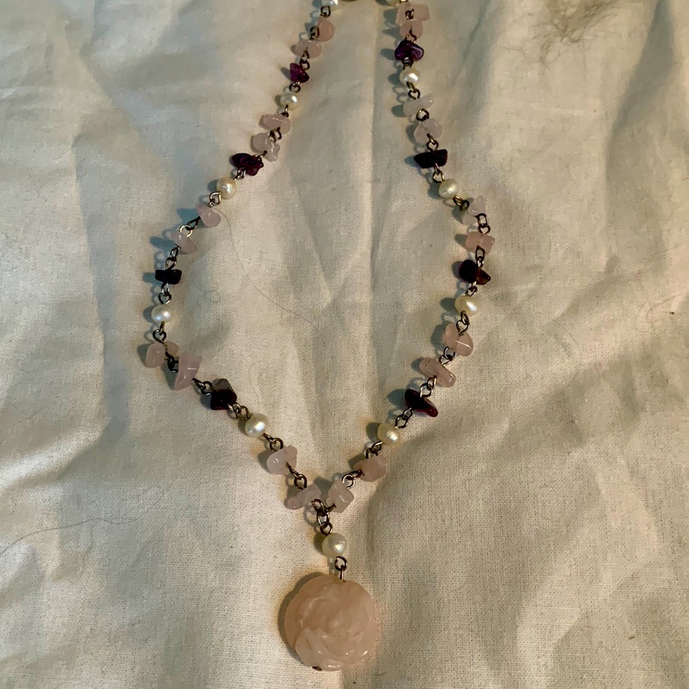 Rose quartz beaded necklace with rose pendant.